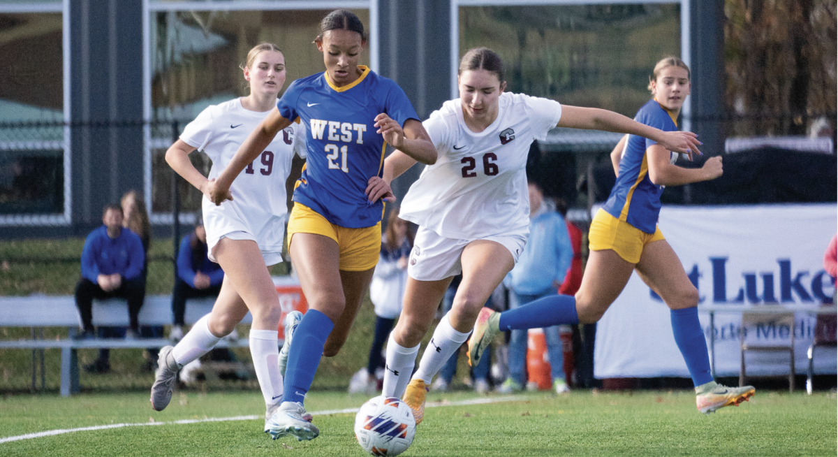 Tackling on turf: Junior Maddie Fox (right) plays against a Downingtown West soccer player at the PIAA 4A State Championship. The girls competed in the state finals for the second year in a row on Nov. 16 and lost 3-2 during overtime.